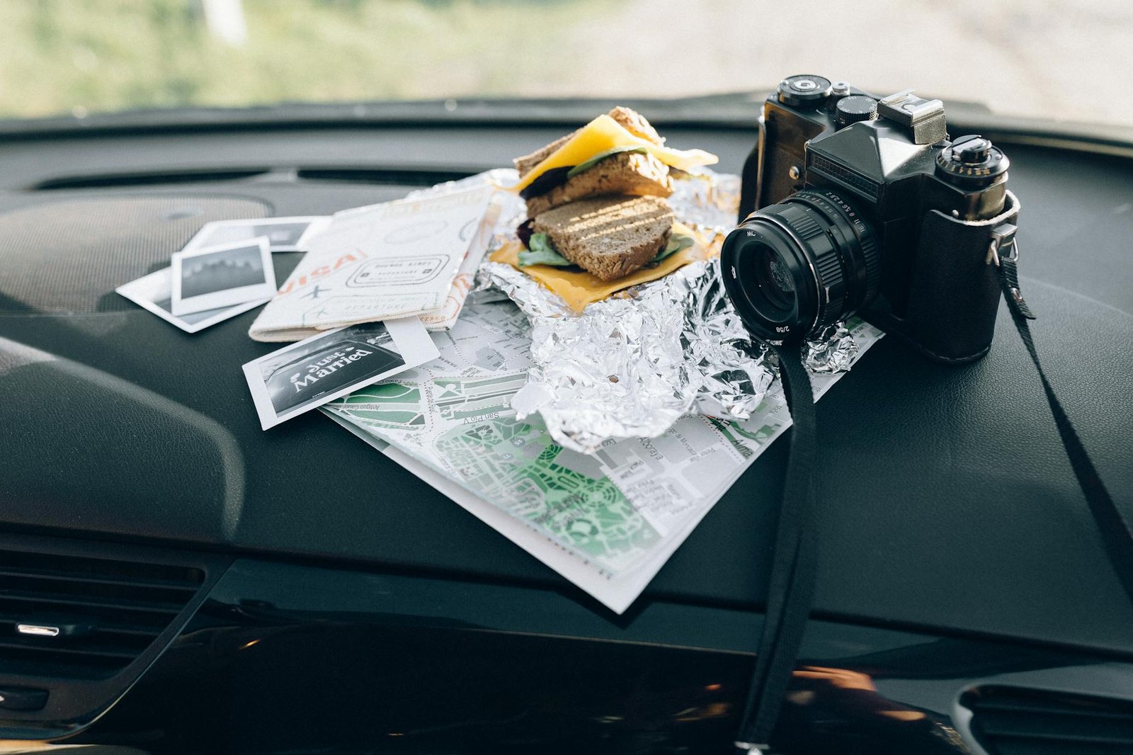 black dslr camera with map and sandwich