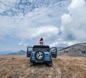 woman on top of a off road vehicle