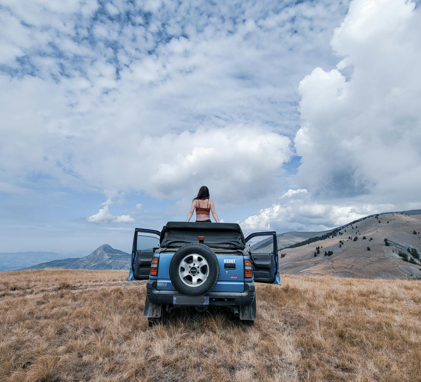 woman on top of a off road vehicle