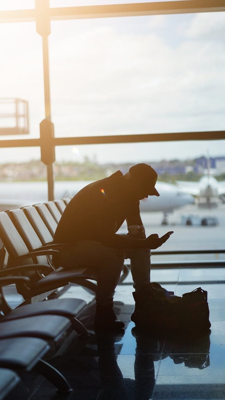 silhouette of a man sitting in the airport